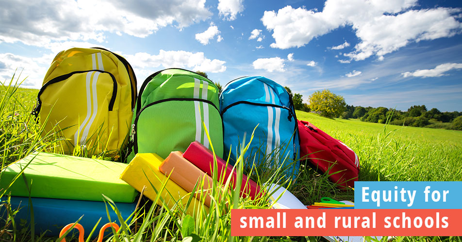 Equity for small and rural schools, colorful backpacks lying together in the grass